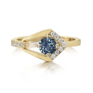 Lady's Yellow 14 Karat Contemporary Fashion Ring Size 7 one 0.59ct Round Bluish Green Sapphire
12=0.18tw Round Diamonds
Type: Ring
Metal Type: 14K Yellow Gold
Gemstone:
5 mm Round Montana Sapphire from Montana, USA (0.59 ct) - 50MS - Enhancement: Heated
Total Gem Weight: 0.59 tcw
Diamonds:
Two 1.75 mm Round Diamonds (0.05 tcw | grade: H-I SI2) - 60D2 - Enhancement: None (Natural)
1.65 mm Round Diamond (0.02 ct | grade: H-I SI2) - 55D2 - Enhancement: None (Natural)
Two 1.575 mm Round Diamonds (0.04 tcw | grade: H-I SI2) - 50D2 - Enhancement: None (Natural)
Three 1.475 mm Round Diamonds (0.04 tcw | grade: H-I SI2) - 40D2 - Enhancement: None (Natural)
Three 1.375 mm Round Diamonds (0.03 tcw | grade: H-I SI2) - 30D2 - Enhancement: None (Natural)
1.275 mm Round Diamond (0.01 ct | grade: H-I SI2) - 20D2 - Enhancement: None (Natural)
Diamond Weight: 0.18 tcw