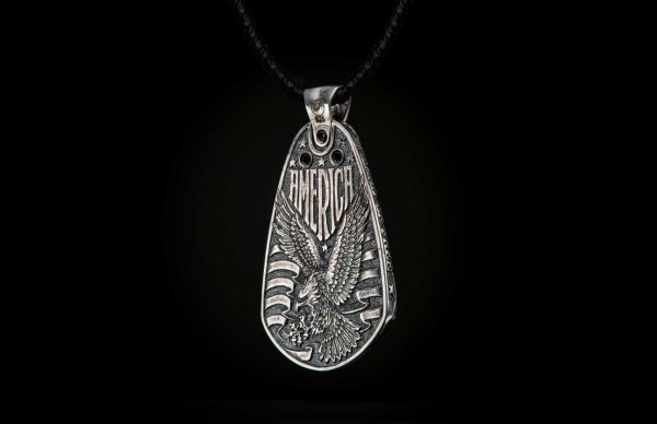 William Henry is proud of our American heritage, and we pay homage to the strength and ideals that created the dream we all share. The Denali is a striking pendant wrought in sterling silver with artwork that captures the iconography of our history. A wishbone clip in PVD black coated stainless steel holds one to three guitar picks, and whether you play guitar or you don’t, this piece is gorgeous on the neck. Finished with a fine stitched leather cord and sterling silver clasp, entirely built in our Oregon studio. - Image 2