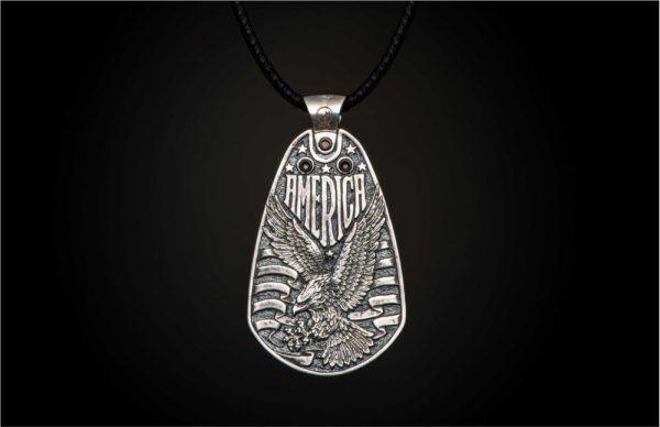 William Henry is proud of our American heritage, and we pay homage to the strength and ideals that created the dream we all share. The Denali is a striking pendant wrought in sterling silver with artwork that captures the iconography of our history. A wishbone clip in PVD black coated stainless steel holds one to three guitar picks, and whether you play guitar or you don’t, this piece is gorgeous on the neck. Finished with a fine stitched leather cord and sterling silver clasp, entirely built in our Oregon studio. - Image 5
