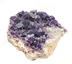 Purple Flourite
So many details and textures to take in on this gemmy purple fluorite.  This specimen is a rare find from the Berbes Mine in Spain which stopped production many years ago.  The distinctive well-formed fluorite crystals are mixed with delicate golden barite “blades”.  We love its complex composition with shades of violet to periwinkle clusters.  The fluorite crystals have defined internal geometric phantoms, displaying outlines of numerous smaller crystals.  Fluorite is also known as “the most colorful mineral in the world” due to the wide range of color variations.

Berbes is a mining area in the province of Ribadesella, Asturias, which is in the northern coast of Spain.  The Berbes Mine is famous for its violet and blue-purple fluorite cubic crystals, and associations with other minerals such as quartz and barite.  Specimens from this area of Spain are coveted by collectors and mineral enthusiasts.

Since the 1930s the area has been mined by competing entrepreneurs and companies.  Due to the physical condition of the mine and lack of financing over the decades, there are fewer and fewer quality specimens.  Due to its scarcity along with its distinctive composition and color, Purple Fluorite from the Berbes Mine is coveted by collectors and mineral enthusiasts alike.

Specimen Locality: Berbes, Berbes Mine, Ribadesella, Asturias, Spain.

Read more about our Purple Fluorite in our LuxeRox Mineral Library
What’s included?

Palm-size specimen crafted by Mother Earth
LuxeRox Lucite Mineral Display stand (4” x 4”)
LuxeRox Velvet Storage Pouch (5” x 6”)
From the desk of LuxeRox: All specimens from LuxeRox are rough natural material.  Every order contains a one-of-a-kind work of art as crafted by Mother Nature.  All specimens will vary slightly in size, color, and shape.  All subscription-based specimens will fit in our signature LuxeRox velvet pouch and mineral stand. Not a single type of specimen will ever be the same.