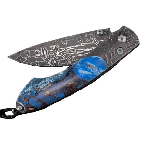 BLUE FUSION
POCKETKNIFE FEATURING ETCHED DAMASCUS, FOSSIL MAMMOTH TUSK, AND DAMASCUS BLADE
PRODUCT DETAILS
The Spearpoint 'Blue Fusion' features a beautiful frame in hand forged 'X-Out' damascus by Chad Nichols. The handle is inlaid with a mesmerizingscale of 'Mammoth Fusion'. The blade is hand-forged 'Intrepid' damascus by Chad Nichols; the one-hand button lock and the thumb stud are set with blue topaz gemstones. A remarkable design that gives you an instrument with a full-size secure grip, and a versatile deep-belly blade, the Spearpoint epitomizes William Henry’s core philosophy – that superlative function deserves to be elevated to superlative art. The ‘Blue Fusion’ features some of the most exotic materials, superlative artistry, and hand-forged metals that are the hallmark of William Henry's collections; a timeless heirloom to be proudly worn and used for a lifetime before being handed-down to another generation.

Product SKU: B12 BLUE FUSION

FEATURES & SPECS
One-hand button lock system
Leather carrying case
Shipped in an elegant wood presentation box
Dimensions: 
Blade 3.06" (77.7mm)
Handle 4.13" (104.9.5mm)
Overall open 7.19" (182.6mm)