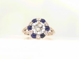 Lady's White 14 Karat  Donut Halo Split Shank Engagement Ring one 1.01ct Round G SI1 Diamond
6=0.12tw Round Diamonds
12=0.18tw Round Diamonds
12=0.06tw Round Diamonds
36=0.09tw Round Diamonds
6= Cabochon Sapphires
EGL9906130937 - Center Diamond Report