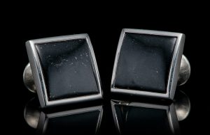 CL BLK J
Every man needs a great classic cufflink – why not make them a little more special? The Black Jade Duo from William Henry is sculpted from solid sterling silver, built to last generations, and inlaid with natural California black jade. The jadeis hand-polished to reveal subtle variations, the texture of one of the most prized natural black stones in the world. Wear them well, and tell your story.