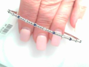 GEMMA COUTURE Lady's White 14 Karat Half Way Natural Diamonds And Blue Sapphires Flexible Bangle Bracelet 6 = 0.12tw Round Blue Sapphires
7 = 0.11tw Round F/G VS2 Diamonds