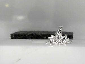 White 18 Karat Flower Spinner Pendant,  0.12tw Round Diamonds