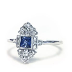 Lady's White 18 Karat Antique Fashion Ring Size 6.5 With 20=0.04Tw Round F/G Vs2 Diamonds And One 0.18Ct Princess Blue Strong Sapphire
Gram Weight: 1.77 gr