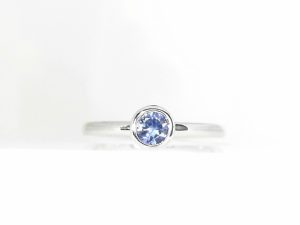 Lady's White 14 Karat Bezel Set Fashion Ring Size 7 With One 0.39Ct Round Blue Sapphire