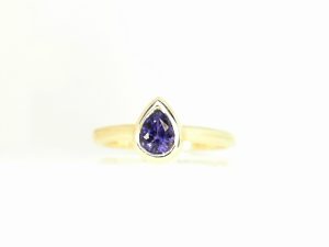 Lady's Yellow 14 Karat Bezel Set Fashion Ring Size 7 With One 0.61Ct Pear Purple Sapphire