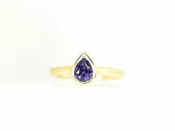 Lady's Yellow 14 Karat Bezel Set Fashion Ring Size 7 With One 0.61Ct Pear Purple Sapphire