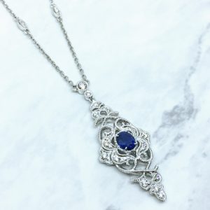 Lady's White 18 Karat Parade in Color Vintage Necklace Length 18/17/16in  With 31=0.20Tw Round F/G Vs2 Diamonds And One 0.37Ct Oval Blue Strong Sapphire
4.62gr