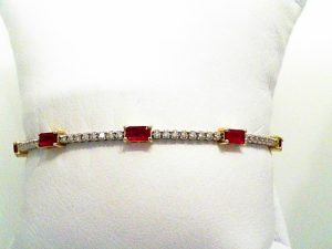 Lady's Yellow 14 Karat Flex  5 Station  Emerald Cut Ruby And Diamond Bracelet 32 = 0.33tw Round G/H SI2 Diamonds
5 = 1.46tw Emerald Red Rubys