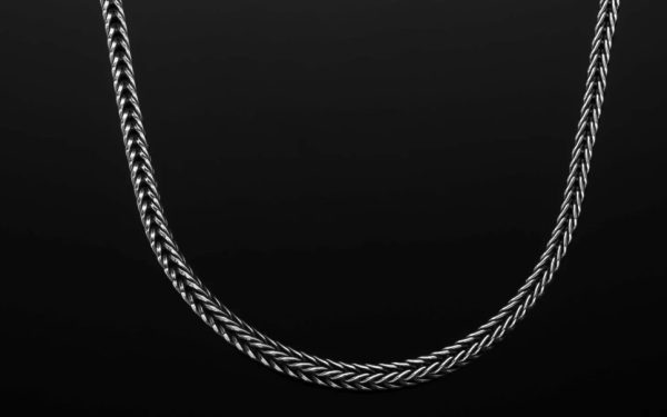 Bold, supple, fluid, snakelike, this foxtail chain in sterling silver is in a league of its own. Beautifully oxidized and hand polished, this complex pattern flows around the neck and draws the eye closer. There are a great many foxtail pattern chains outthere, but precious few that rise to the level of art on their own. Finished with our custom lobster clasp

Sterling Silver Foxtail Chain 22' - Image 2