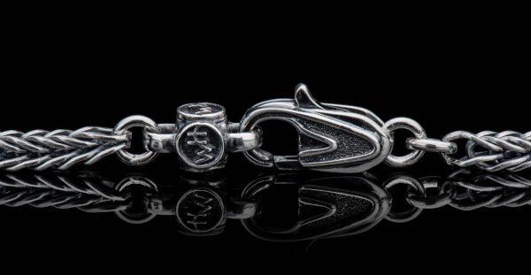 Bold, supple, fluid, snakelike, this foxtail chain in sterling silver is in a league of its own. Beautifully oxidized and hand polished, this complex pattern flows around the neck and draws the eye closer. There are a great many foxtail pattern chains outthere, but precious few that rise to the level of art on their own. Finished with our custom lobster clasp

Sterling Silver Foxtail Chain 22' - Image 3