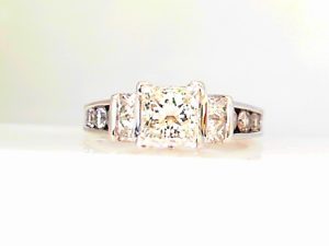 Lady's White 14 Karat Contemporary Engagement Ring Size 6.75 one 1.20ct Princess H VS1 Diamond V-Tip Prong Set 
GIA REPORT  6412352412 INSCRIPTION: GIA 6412352412
10=0.68tw Round H/I SI2 Diamonds-Channel Set 
4=0.20tw Princess H/I SI2 Diamonds -Bezel Set