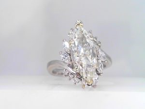 Lady's White Platinum Contemporary Engagement Ring Size 6.25 one 1.62ct Marquise I VS1 Diamond
8=0.15tw Round G/H SI1 Diamonds
6=0.72tw Marquise G/H SI1 Diamonds