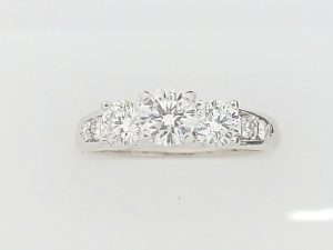 Lady's White 18 Karat 3 Stone Engagement Ring Size 7 one = 0.46ct Round F/G VS2 Diamond
2 = 0.50tw Round F/G VS2 Diamonds
4 = 0.08tw Round F/G VS2 Diamonds