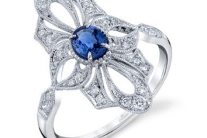 Lady's White 18 Karat Antique Fashion Ring Size 6.5 With One 0.36Ct Oval Blue Strong Sapphire And 26=0.25Tw Round F/G Vs2 Diamonds
Gram Wt.: 3.24 gr