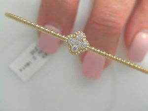 GEMMA COUTURE Lady's Yellow 14 Karat Flexible Ball Bangle With Diamond Flower Center Bracelet 5 = 0.18tw Round G SI1 Diamonds