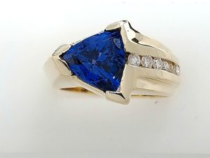Lady's Yellow 14 Karat Fashion Fashion Ring Size 7 With One = 2.00Ct Trillian Tanzanite And 6 = 0.24Tw Round F/G Si1 Diamonds