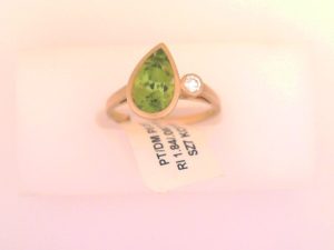 Lady's Yellow 18 Karat Matte' Bezel Set 18Ky Peridot Ring With Single Diamond Stone Fashion Ring Size 7 one = 1.84ct Pear Green Strong Peridot
one = 0.08ct Round F/G Diamond