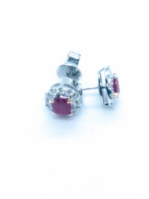 Lady's Two Tone White/Yellow 18 Karat Halo Stud Earrings With 2=0.67Tw Oval Red Rubys And 24=0.26Tw Round G/H Vs2 Diamonds