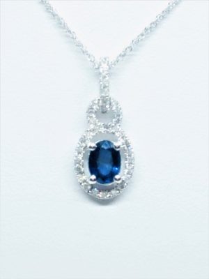 White 18 Karat Halo Pendant With One 0.81Ct Oval Blue Sapphire And 33=0.18Tw Round G Si1 Diamonds