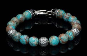 The Seaside takes center stage on the wrist – big enough to really make statement but still comfortable and designed for anything from denim to business attire. Three finely sculpted beads in sterling silver are surrounded by the cool earth tones of BlueLace Agate, all threaded onto our welded stainless steel aircraft cable for durability. Each bracelet is finished with our end caps and a custom lobster clasp wrought from sterling silver.

Product SKU: BB50 BLA