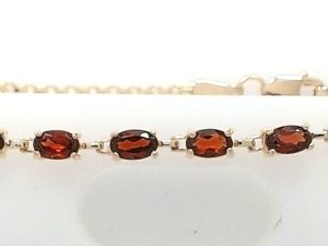 Lady's Yellow 10 Karat Cable Link Bracelet Length 7 With 6 = Oval Red Garnets