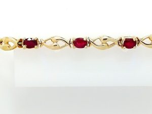 Lady's Yellow 14 Karat Fancy Link Bracelet Length 7 With 12 = Oval Rubys