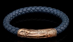 Blue Bronze Engraved Blue Lthr Great Smokey Bracelet Length 8.5 SZ LG
The Great Smoky brings our honored American heritage to life, timeless images sculpted from generations past, and for generations into the future. This bracelet features a beautifullycarved centerpiece/clasp in bronze with a double secured magnetic closure. The soft warmth of the bronze is measured against a supple and durable 8mm braided leather cord in an earth-tone blue/gray that wears well with any outfit, on any occasion. Our leather jewelry features old world craftsmanship in either sterling silver or bronze with secure magnetic closures. Rendered with the heart of rock and roll, this leather collection ages beautifully and conforms to the owner the more it is worn.