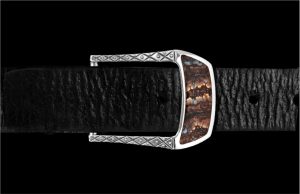 This beautiful belt buckle works from the street to the boardroom, and it creates an elegant accent to any attire. Sculpted in solid sterling silver, the highlight is an amazing inlay of Wooly Mammoth Tooth. Each inlay is hand-polished from a slice of themolar tooth of the Wooly Mammoth, the legendary creature that roamed Earth from 6000-10000 years ago. Fits any 1.25” (1 and ¼” wide) belt that allows for interchanging buckles.
William Henry's fossil Mammoth tooth is harvested in Alaska and Siberia. It is a rare and mesmerizing material, a living testimony of the dawn of Mankind.