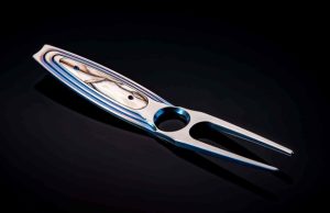 William Henry Eagle (031/500) Titanium Divot Tool - Inlaid With Fossil Wooly Mammoth Tusk with Leather Carrying Case.
Up your game! Or at least your style while out on the links with this gorgeous divot tool from William Henry. The 'Eagle' features a solid body machined from aerospace grade titanium billet and hand-polished to a beautiful satin luster. The oversized chamfered hole gives your thumb a great resting point for control during use (and it looks cool, too). Featuring a mirror polished inlay of fossil Woolly Mammoth tusk, and set with blue anodized titanium screws. Finishing touches include selective blue anodizing on the titanium body, and our classic ClipCase for easy and safe carry. Designed and executed for a few hundred years of service...